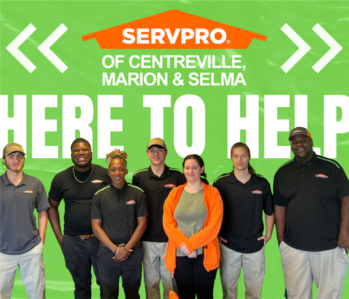 Men and women who are apart of SERVPRO of Centreville, Marion & Selma are smiling at the camera.